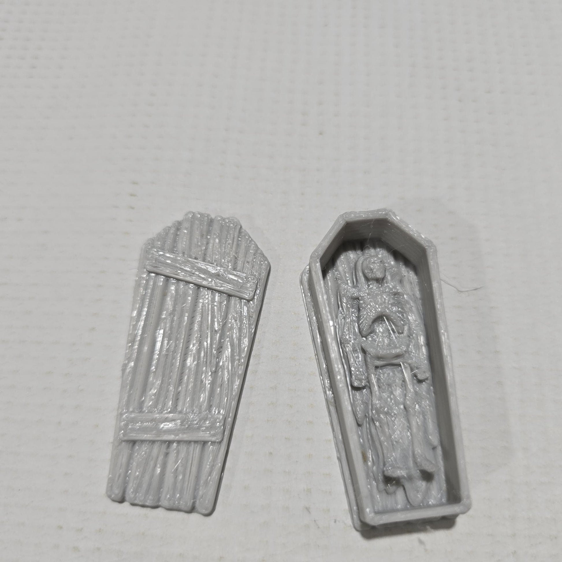 3D-printed flat grave plots for tabletop RPGs like DnD and Pathfinder. Includes detailed gravestones, flat grave markers, and realistic textures. Perfect for creating a somber, immersive cemetery setting in fantasy and historical gaming scenarios.