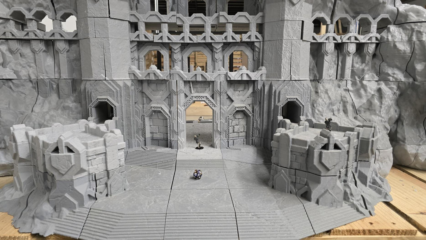 3D printed model of a Dwarf Mountain Stronghold, featuring towering stone structures, fortified walls, and intricate mountain carvings. The fortress includes multiple levels and archways, ideal for enhancing fantasy RPGs and wargaming scenarios.