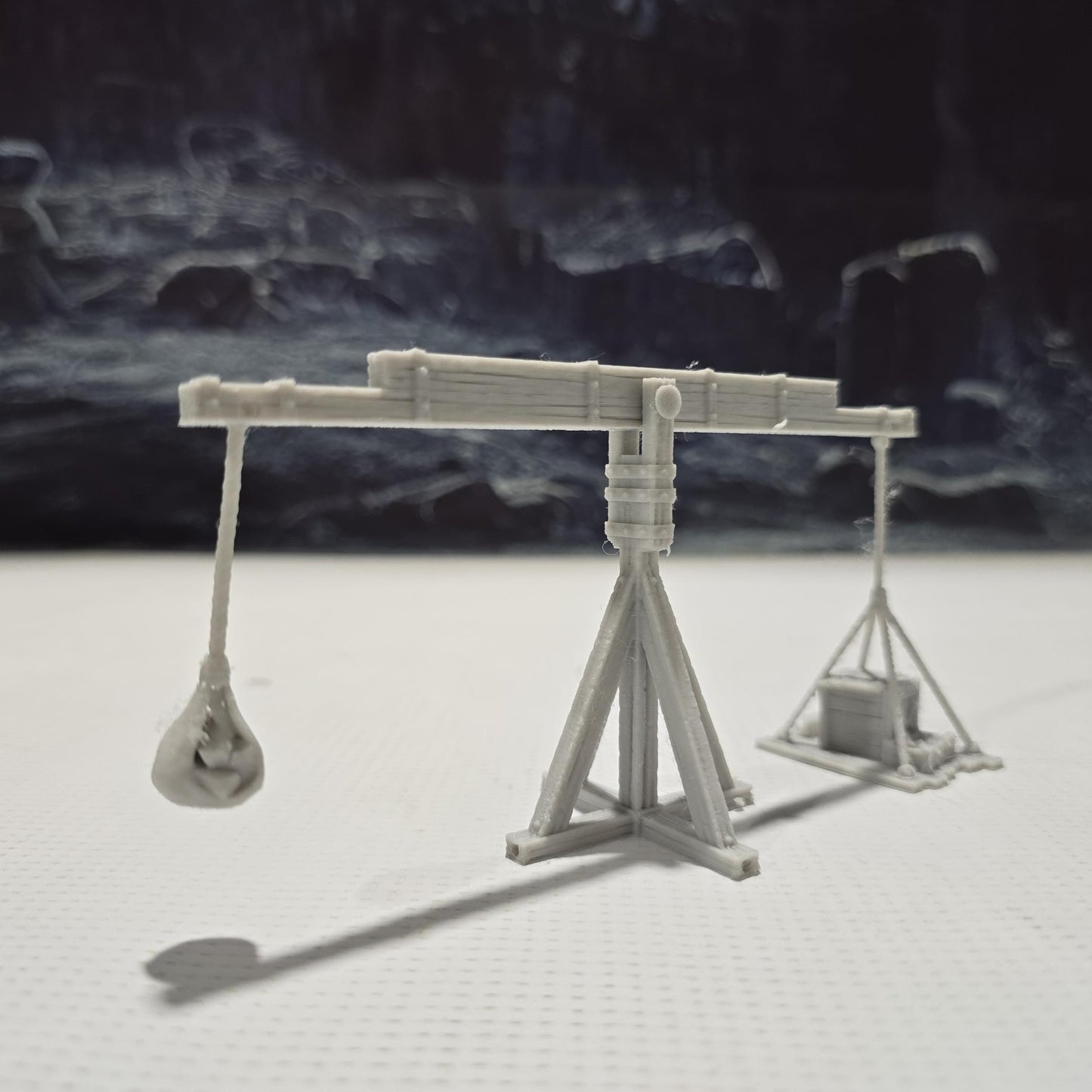 The Balance Crane model features a detailed counterweight mechanism, a pivoting boom, and a realistic wooden frame, perfect for medieval and fantasy tabletop settings.