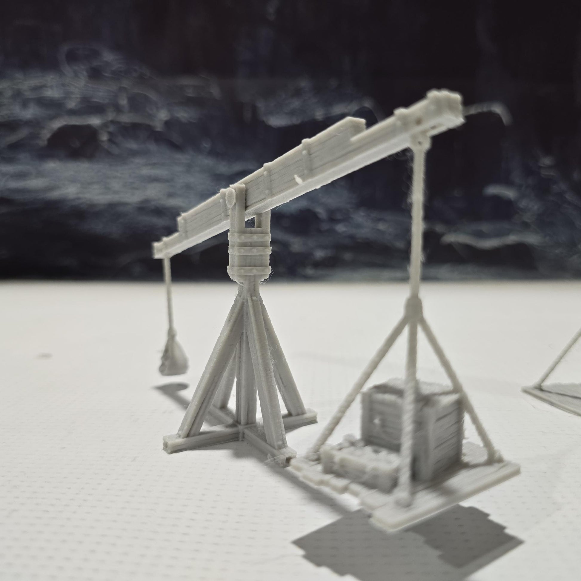 The Balance Crane model features a detailed counterweight mechanism, a pivoting boom, and a realistic wooden frame, perfect for medieval and fantasy tabletop settings.