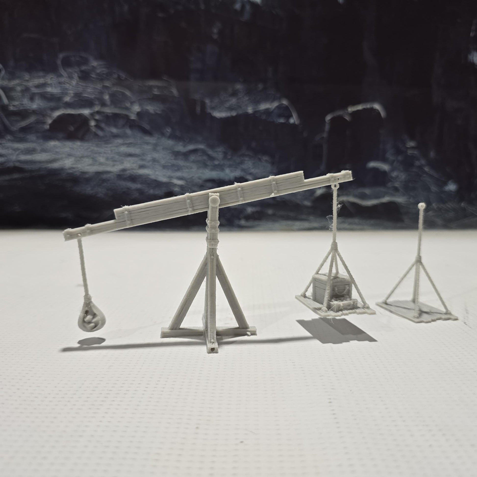 The Balance Crane model features a detailed counterweight mechanism, a pivoting boom, and a realistic wooden frame, perfect for medieval and fantasy tabletop settings.