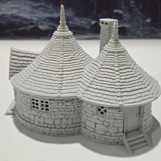 A highly detailed 3D-printed model of the Dragonspire Gamekeeper&#39;s Lodge, featuring two rooms, a fireplace with chimney, front and back doors, and a round roof design.