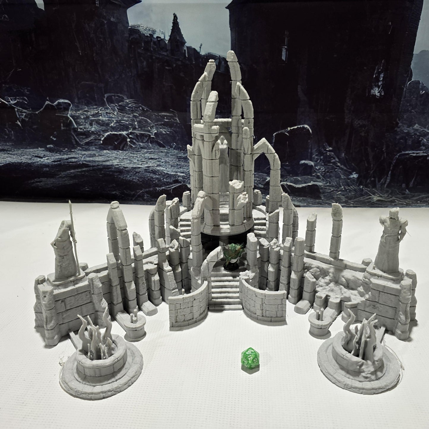 A detailed ruined elven altar featuring intricate carvings and statues, with a central spiral column and surrounding broken pillars. The scene includes multiple staircases and platforms, providing a mystical and ancient ambiance for tabletop games.