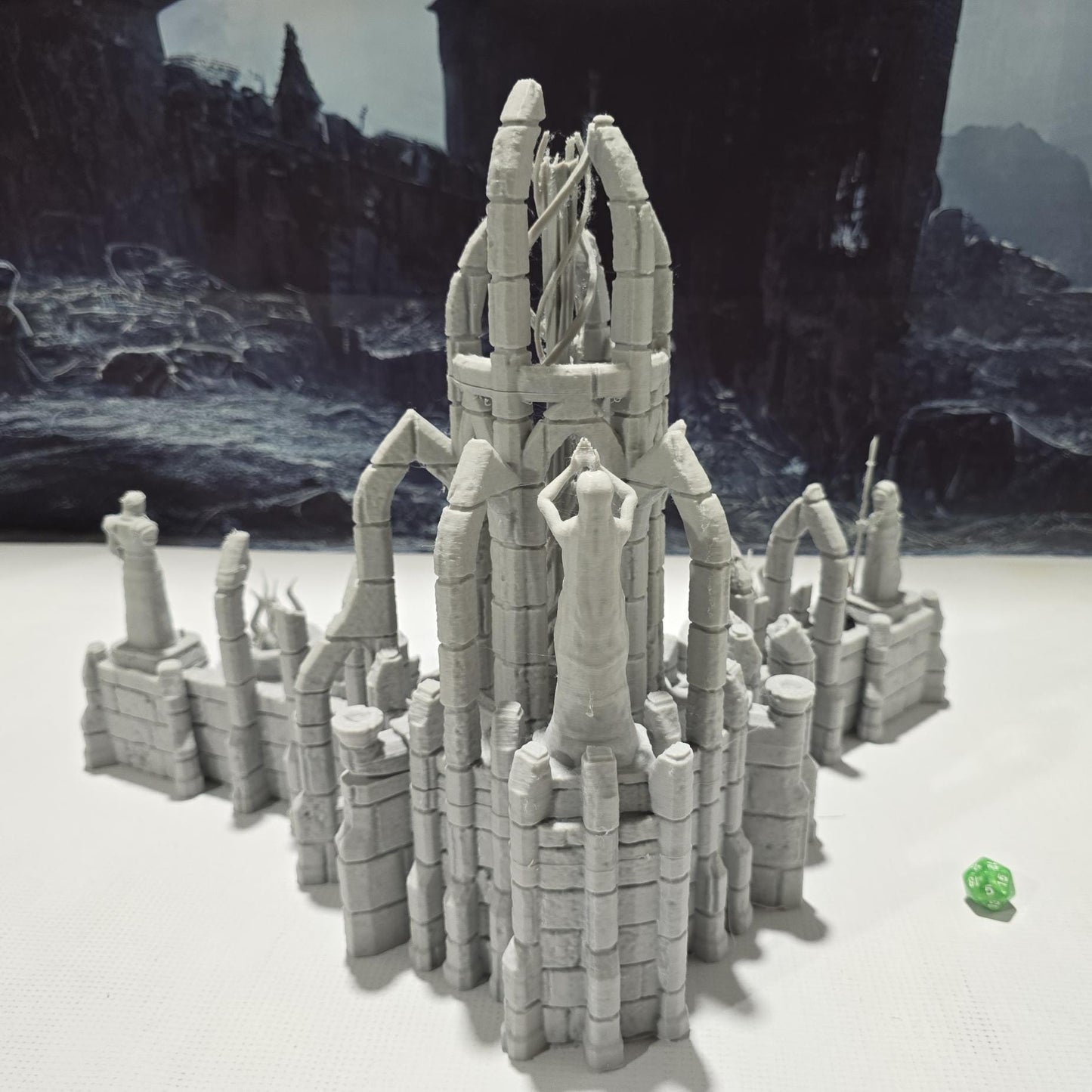 A detailed ruined elven altar featuring intricate carvings and statues, with a central spiral column and surrounding broken pillars. The scene includes multiple staircases and platforms, providing a mystical and ancient ambiance for tabletop games.