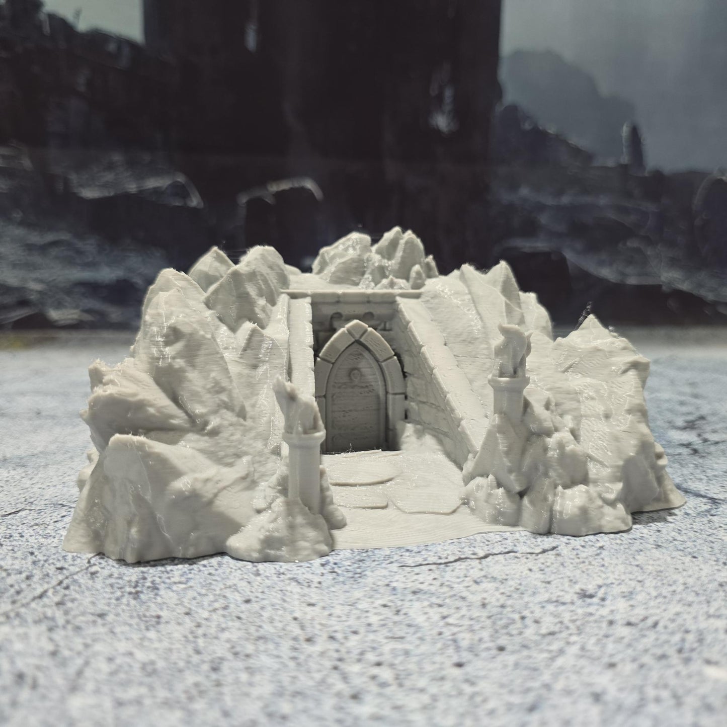 Discover the Drenn Cave Entrance, a detailed fantasy terrain piece featuring a weathered stone entrance guarded by ancient statues. Perfect for adding depth to your tabletop RPGs and wargames. Crafted from durable PLA