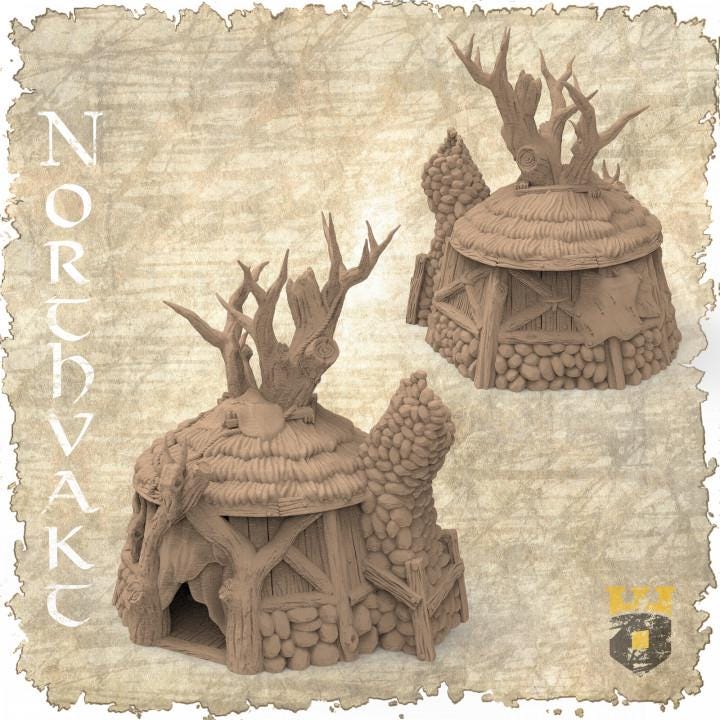 Detailed view of a Norse Shaman Hut model with a thatched roof and antler decorations, designed for use in fantasy and historical tabletop games.