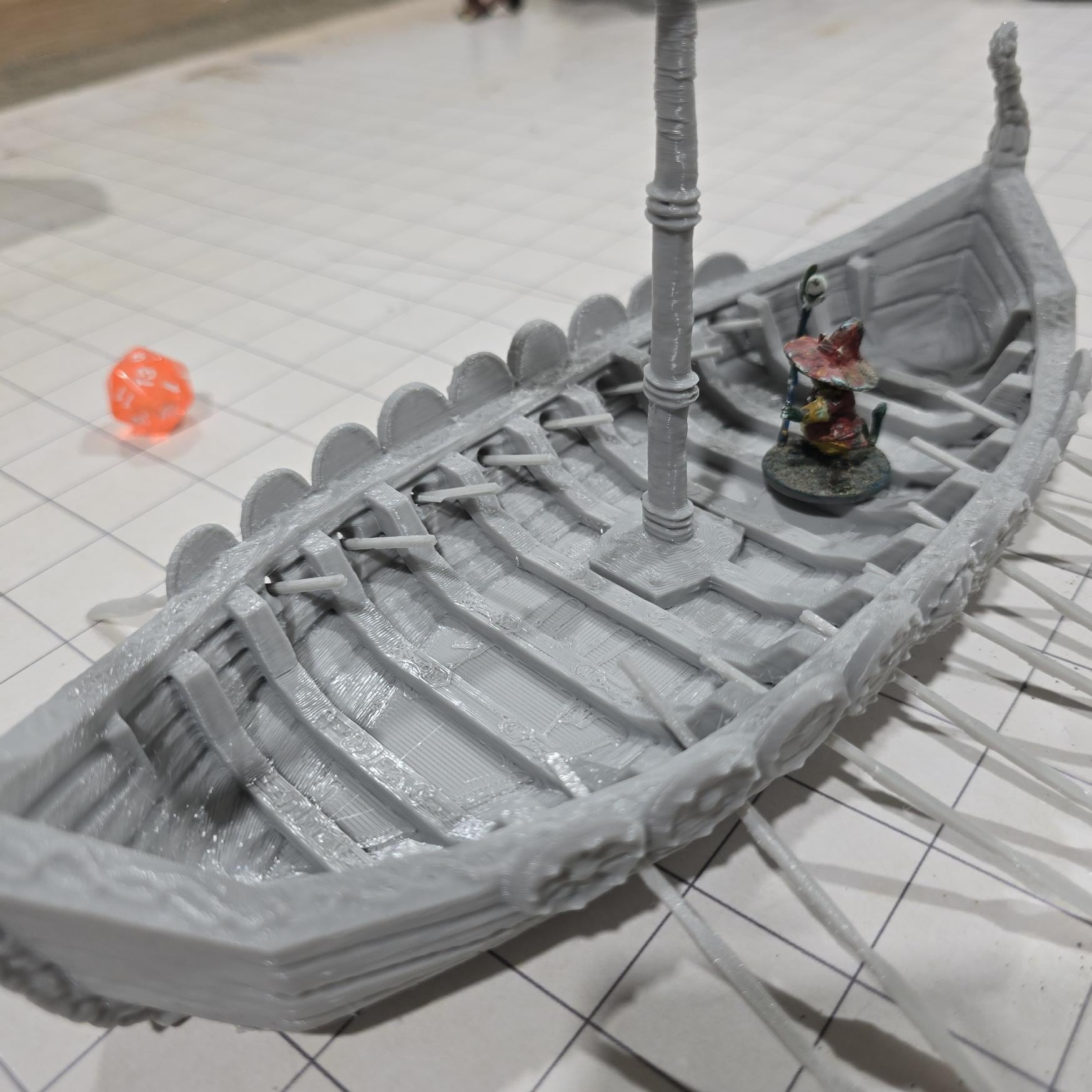 Detailed model of a Viking Long Ship with ornate carvings and shields, designed for use in tabletop RPGs and historical reenactments.